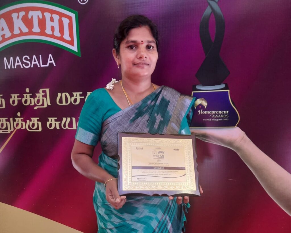 Sudha with Award for upcoming entrepreneurs